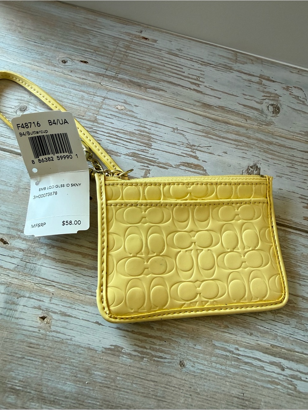 Coach wristlet Buttercup Yellow Signature Embossed Wristlet NWT